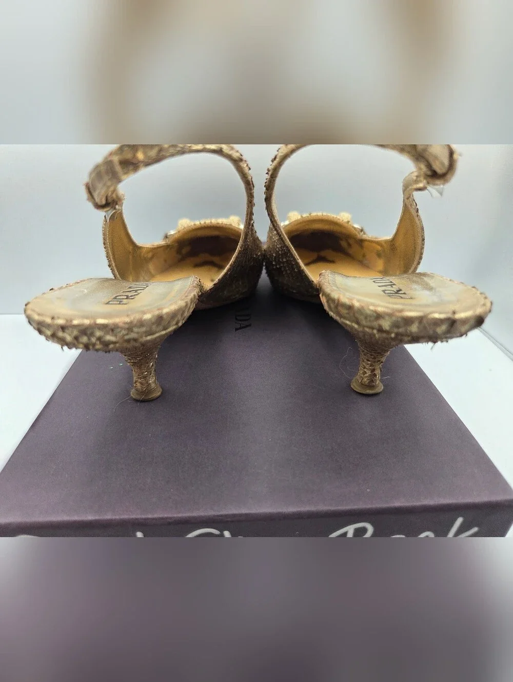 Pre- owned Prada snakeskin braided accents slingback pumps in a metallic gold